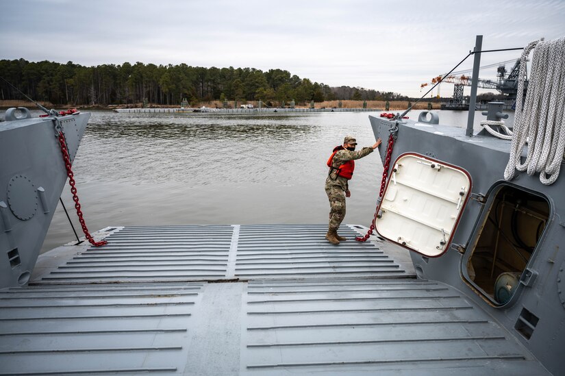 A Soldier stands on a boat.