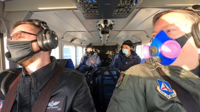 Lt. Col. Robert Bowden, Michigan Wing Civil Air Patrol, and Maj. Rod Rakic, Illinois Wing Civil Air Patrol, fly a mission to distribute COVID vaccine in Michigan while two U.S. Public Health Service officers monitor cooler temperatures in back of the plane. The mission was part of an interagency agreement between the Civil Air Patrol and U.S. Department of Health and Human Services – Indian Health Service. Authorized under the Economy Act, the agreement allowed CAP to act as a Civilian Auxiliary of the Air Force, and fly the vaccine inside a 12-hour period to prevent spoilage.  (Civil Air Patrol photo)