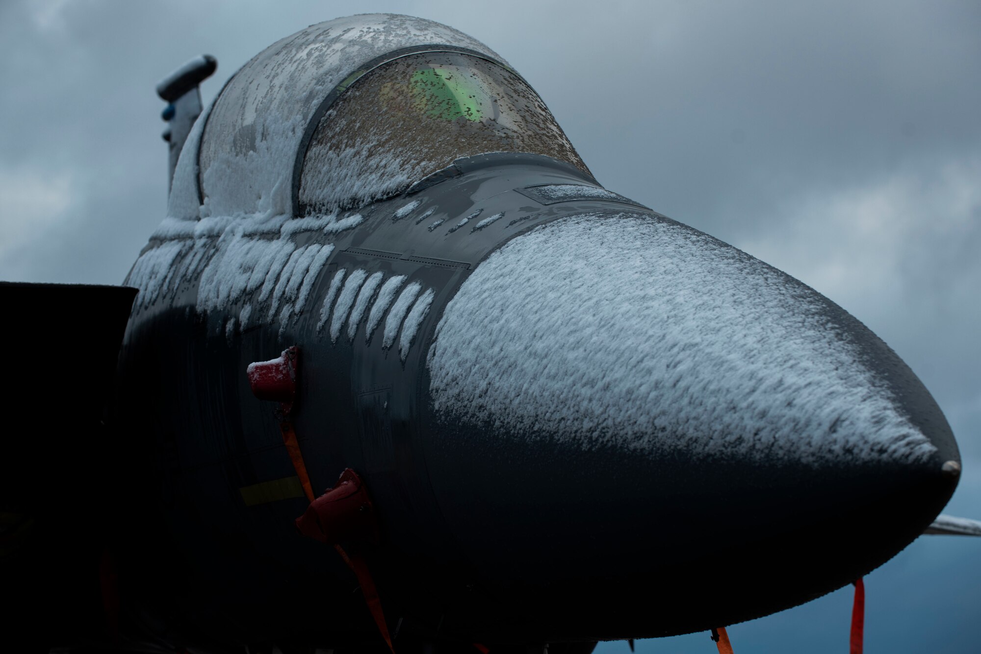 An F-15E Strike Eagle from the 334th Fighter Squadron is covered in snow at Seymour Johnson Air Force Base, North Carolina, Jan. 28, 2021.