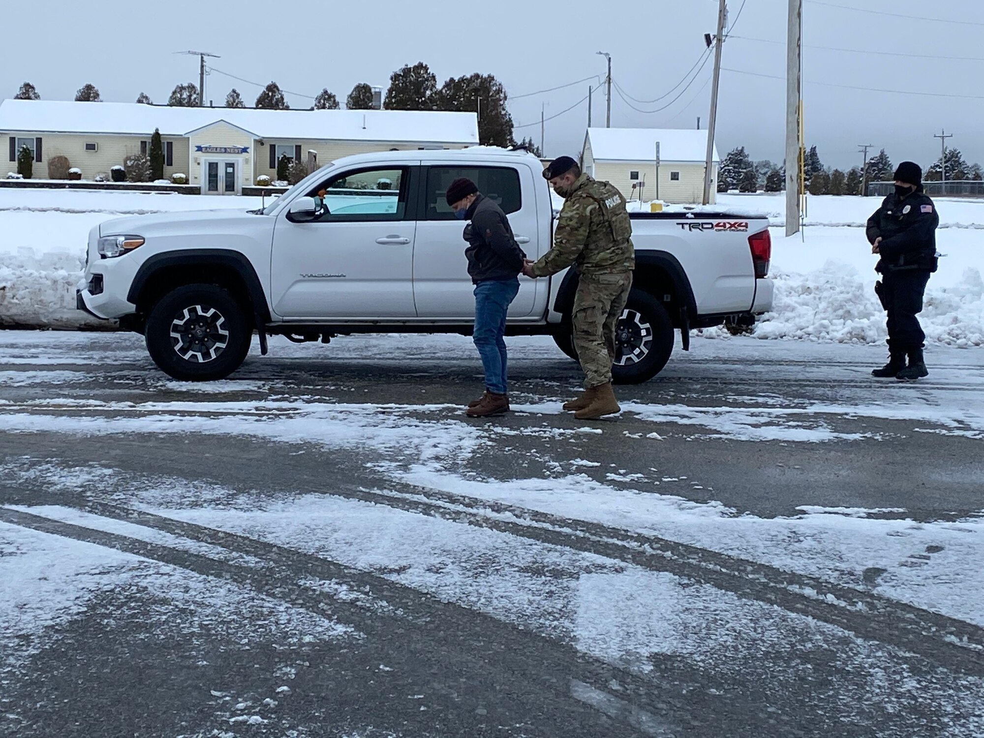 Photo of the "perpetrator", 102 IW Director of Inspections, Mr. Scott Etler, was hand-cuffed and both he and his vehicle were searched by Patrolman Staff Sgt. Erik Madden. Providing backup was Entry Controller Mr. Christopher Hankins.