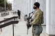 Soldier stands guard with rifle