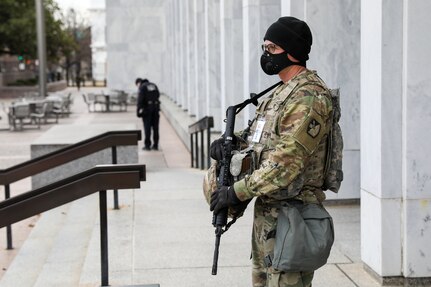 Soldier stands guard with rifle