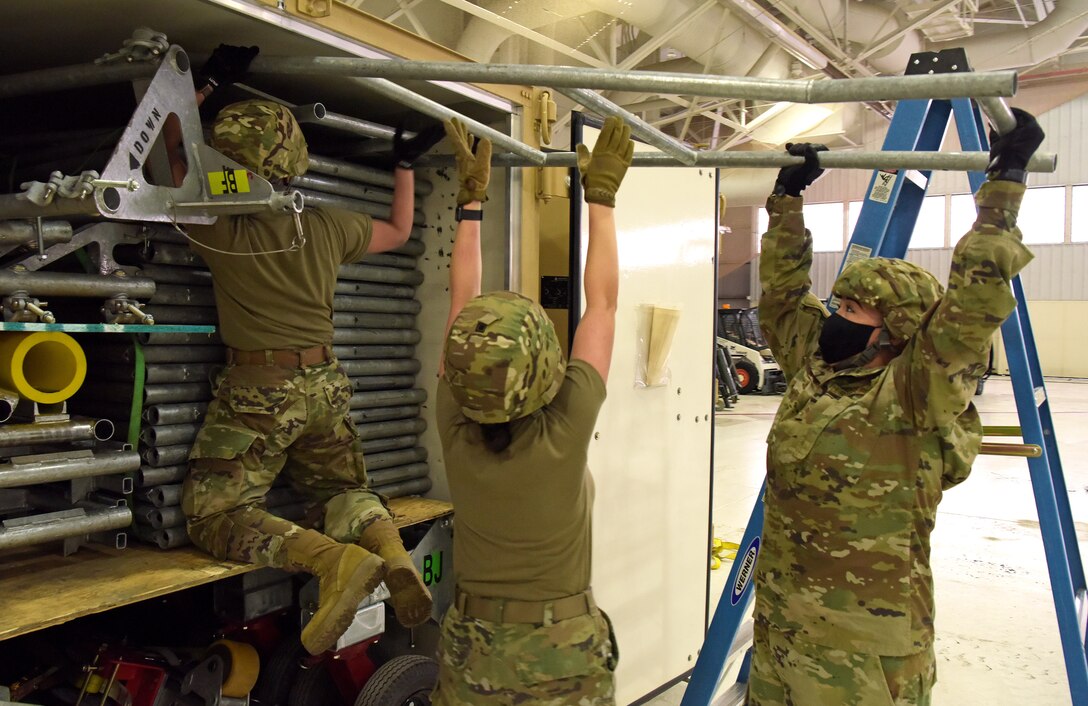 Medical technicians from the 375th Medical Group begin constructing the Patient Loading System at Scott Air Force Base, Illinois, Jan. 26, 2021. The PLS is a portable and constructable ramp used to safely on- and off-load patients to high-deck aircraft, such as the KC-10 Extender, KC-46 Pegasus and KC-135 Stratotanker. (U.S. Air Force photo by Master Sgt. R.J. Biermann)