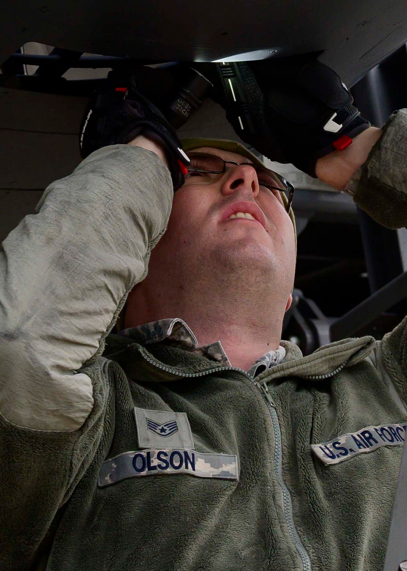 Photo of Airman working on a jet engine.