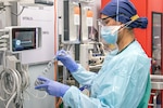 U.S. Air Force Tech. Sgt. Jarimaris Garcia, a registered nurse stationed at Joint Base Andrews, Maryland, prepares medical equipment for incoming patients within the emergency department of Del Sol Medical Center, El Paso, Texas, Nov. 24, 2020.