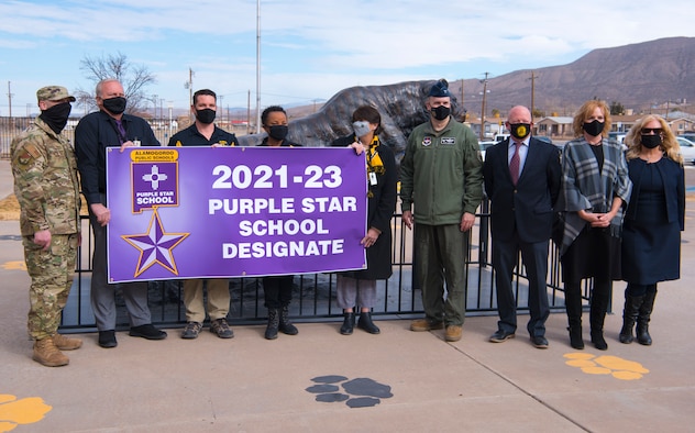 49th Wing leadership and Alamogordo Public School District leadership pose for a photo with Purple Star School Designate banner, Jan. 19, 2021, at Alamogordo, New Mexico. The designation is for two years and it allows the campus to carry the banner of Alamogordo public schools Purple Star on their campus and on its website. (U.S. Air Force photo by Airman 1st Class Jessica Sanchez)