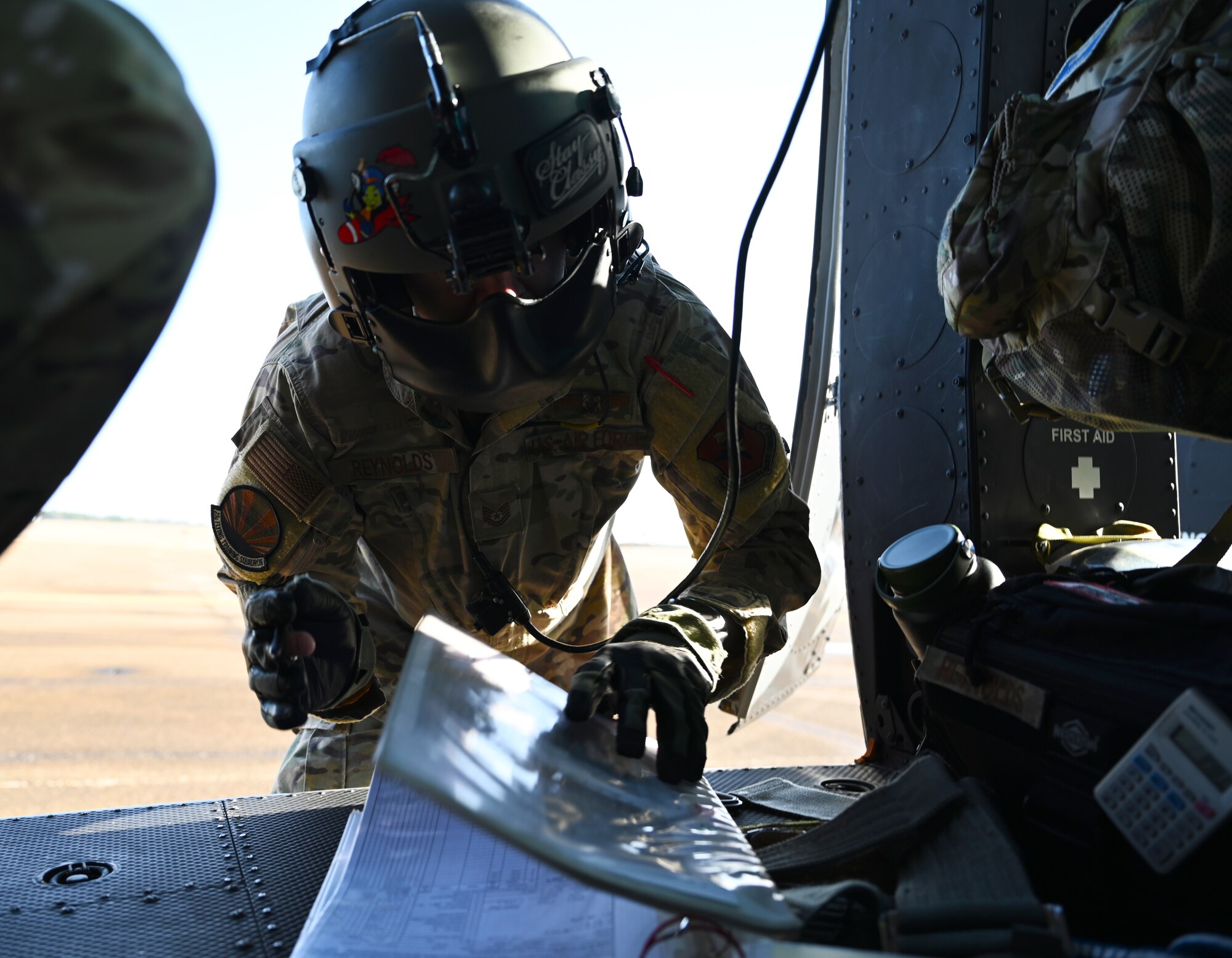 U.S. Air Force Tech. Sgt. Hayden Reynolds, 23rd Flying Training Squadron instructor flight engineer, looks over a TH-1H Huey checklist before takeoff Jan. 26, 2021, on Columbus Air Force Base, Miss. Upon clearing tests, TH-1Hs were released to the Air Education and Training Command to better prepare student pilots for platforms they'll use in their careers. (U.S. Air Force photo by Senior Airman Jake Jacobsen)