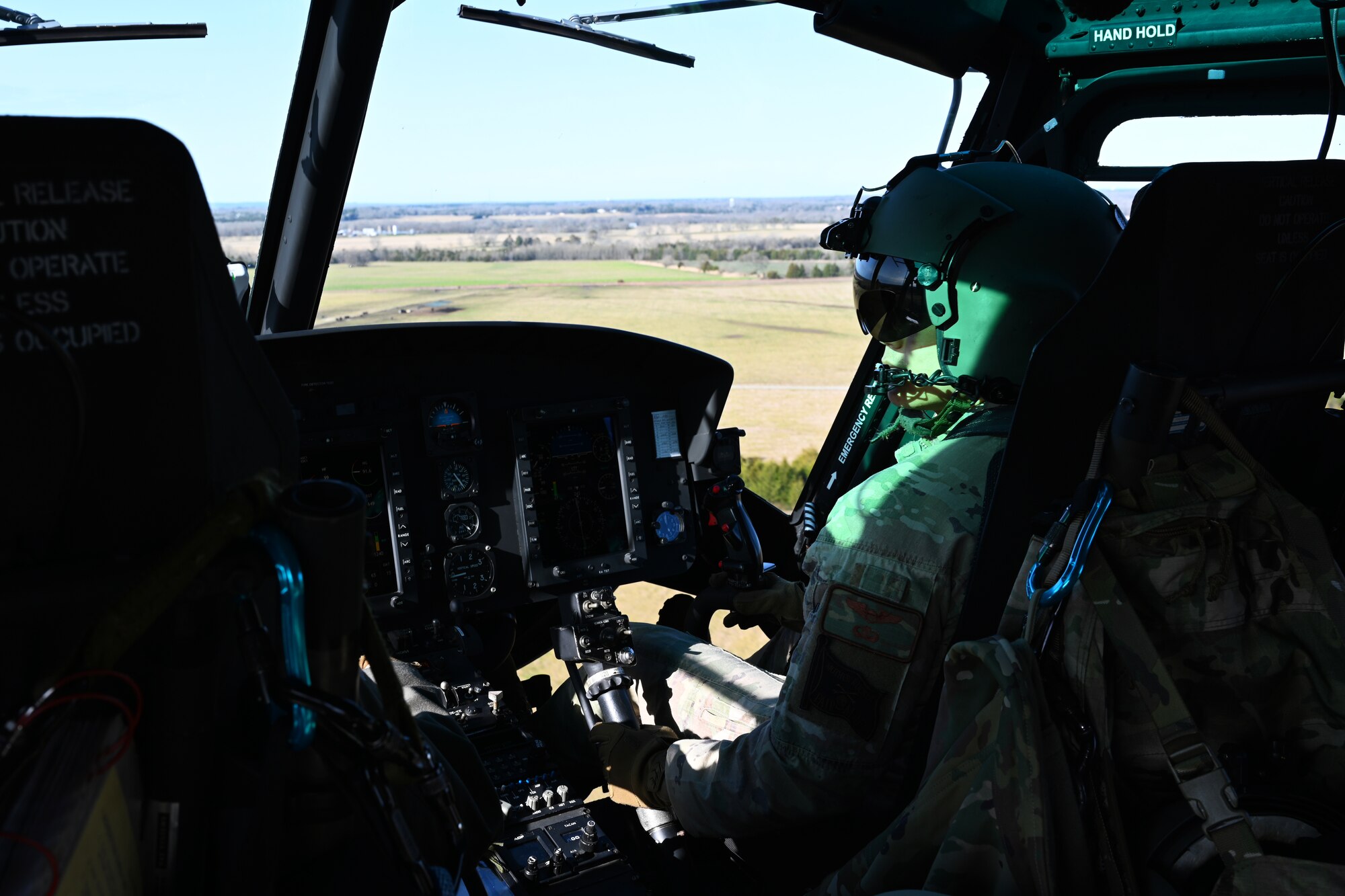 U.S. Air Force 1st Lt. Austin Kong, 23rd Flying Training Squadron instructor pilot, maneuvers a TH-1H Huey during an aircraft familiarization flight for instructor and student pilots from the 14th Student Squadron, Jan. 26, 2021, on Columbus Air Force Base, Miss. During pilot training, students at Columbus AFB only fly the T-6 Texas II, T- 38C Talon, and T- 1A Jayhawk. The aircraft familiarization flight gave them an opportunity to experience new aircraft. (U.S. Air Force photo by Senior Airman Jake Jacobsen)