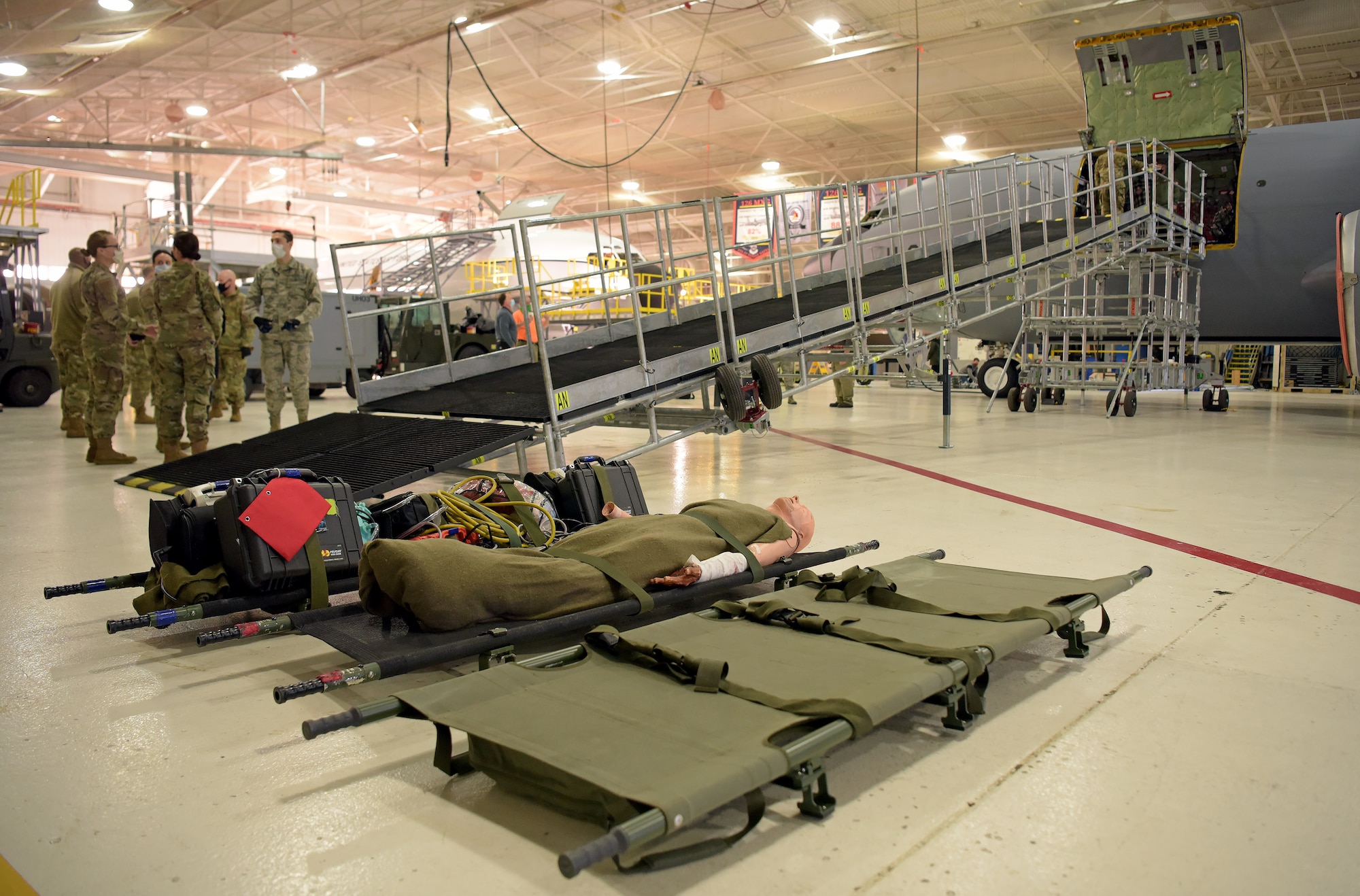 Medical technicians from the 375th Medical Group prepare to transport litters up a newly constructed Patient Loading System at Scott Air Force Base, Illinois, Jan. 26, 2021. The PLS is a portable and constructable ramp used to safely on- and off-load patients to high-deck aircraft, such as the KC-10 Extender, KC-46 Pegasus and KC-135 Stratotanker. (U.S. Air Force photo by Master Sgt. R.J. Biermann)