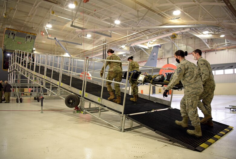 Medical technicians from the 375th Medical Group transport litters up a newly constructed Patient Loading System at Scott Air Force Base, Illinois, Jan. 26, 2021. The PLS is a portable and constructable ramp used to safely on- and off-load patients to high-deck aircraft, such as the KC-10 Extender, KC-46 Pegasus and KC-135 Stratotanker. (U.S. Air Force photo by Master Sgt. R.J. Biermann)