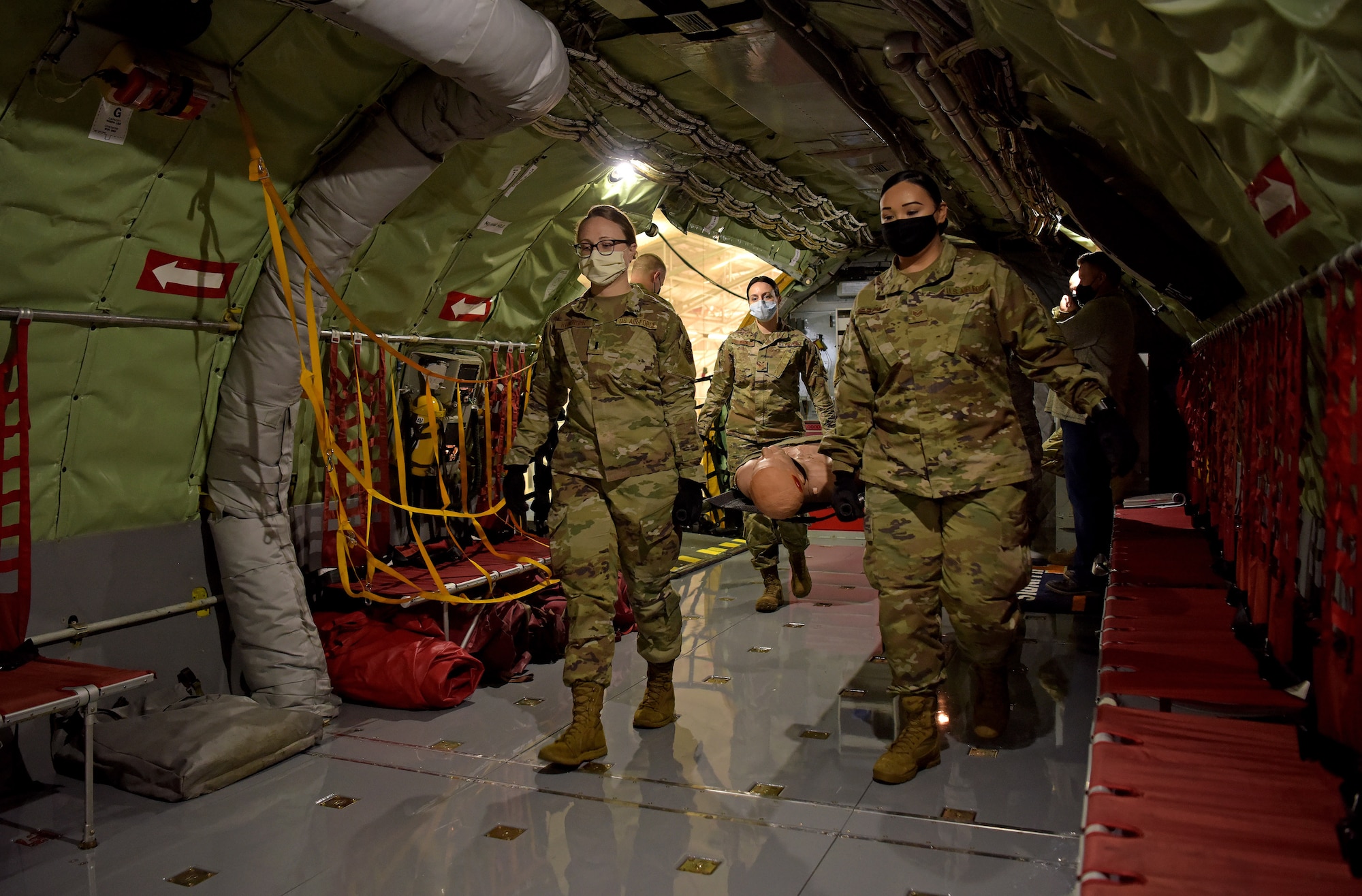 Medical technicians from the 375th Medical Group transport litters up a newly constructed Patient Loading System and onto a KC-135 Stratotanker at Scott Air Force Base, Illinois, Jan. 26, 2021. The PLS is a portable and constructable ramp used to safely on- and off-load patients to high-deck aircraft, such as the KC-10 Extender, KC-46 Pegasus and KC-135 Stratotanker. (U.S. Air Force photo by Master Sgt. R.J. Biermann)
