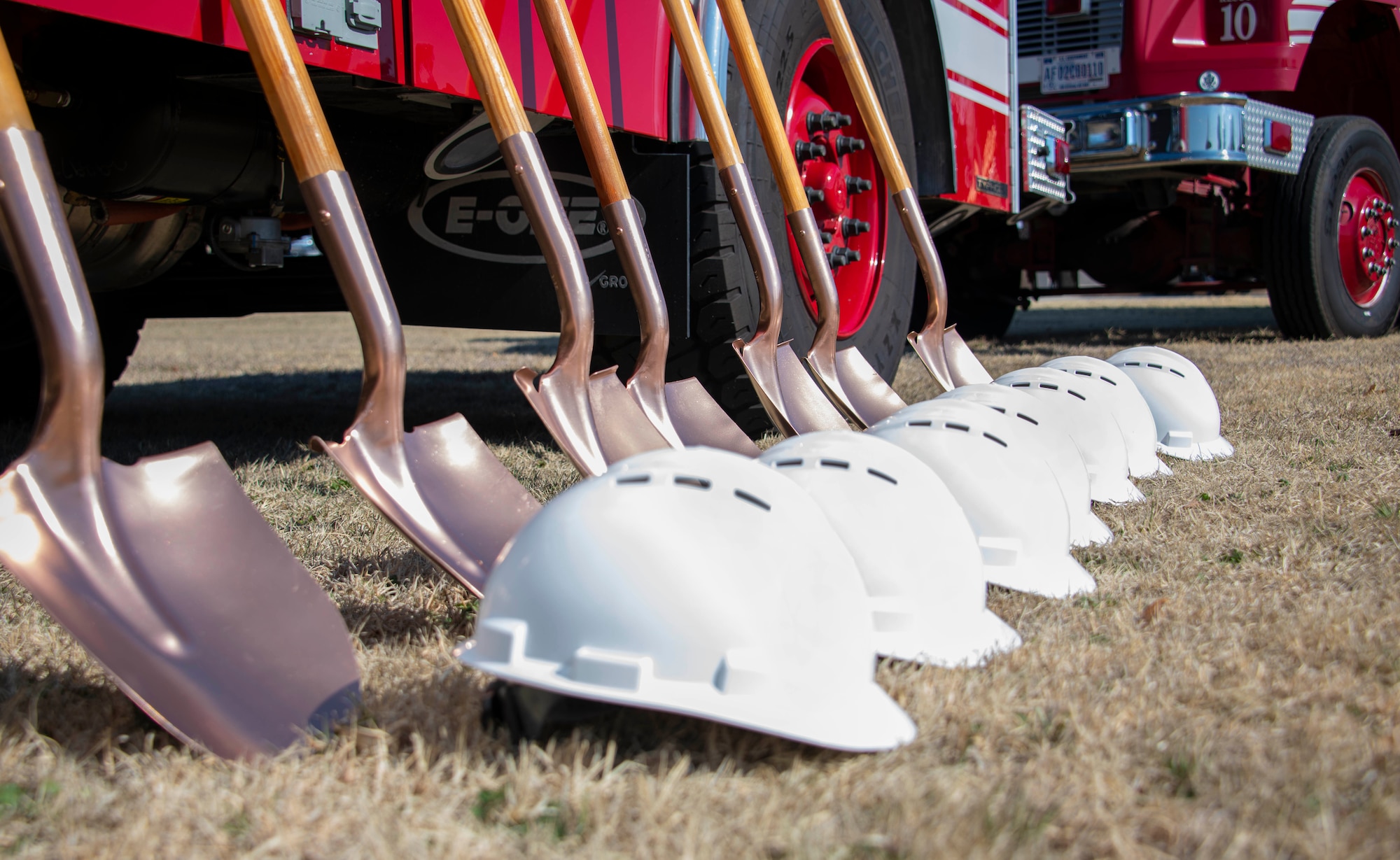 Shovels and helmets are displayed at the Fire Rescue Center ground breaking ceremony at Altus Air Force Base, Oklahoma, Jan. 26, 2021. The shovels and helmets were given to the 97th Air Mobility Wing leadership team and distinguished guests who used them to perform the "first dig." (U.S. Air Force photo by Airman 1st Class Amanda Lovelace)