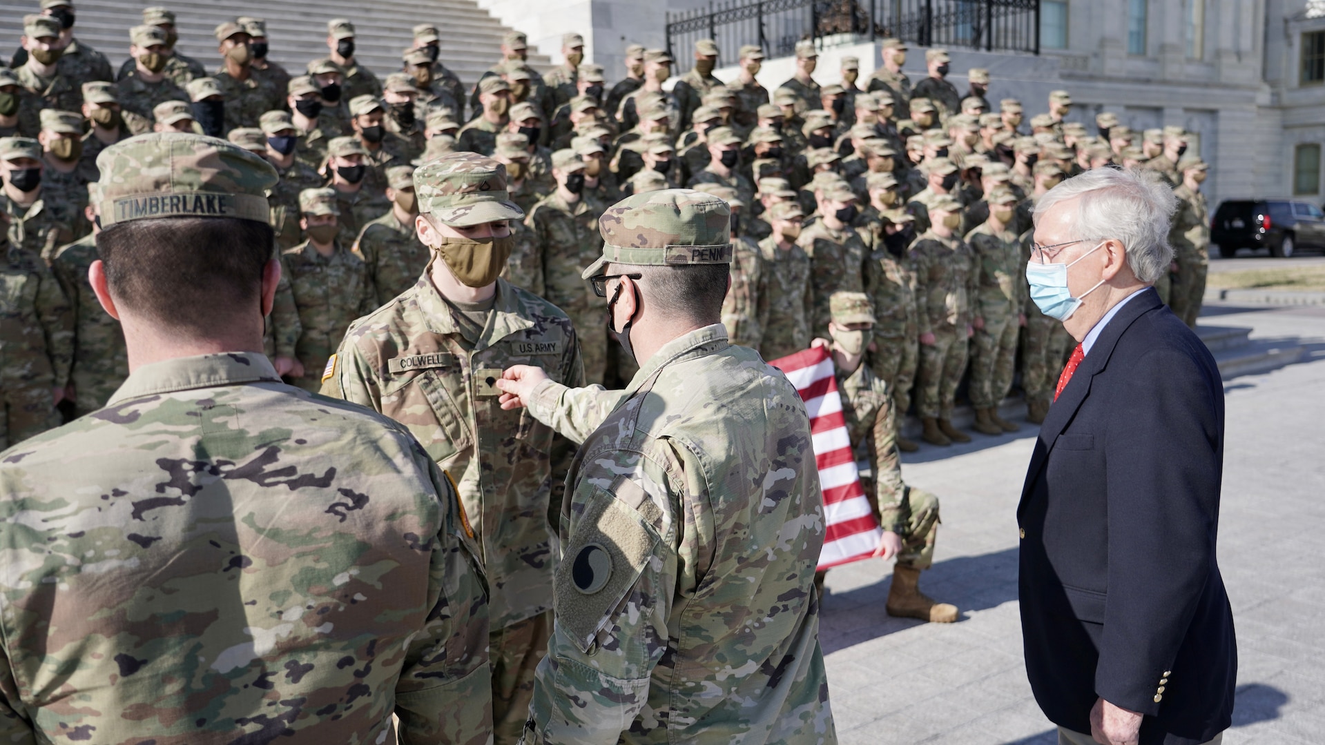 Lt. Col. Jason Penn, 1-149th Infantry commander, promotes Spc. Dakota Colwell with Alpha Company, 1-149th Infantry, at the U.S. Capitol in Washington Jan. 22, 2021. At least 25,000 National Guard men and women assisted local and federal authorities for the inauguration. About 150 Kentucky National Guard Soldiers will assist in Washington through March.