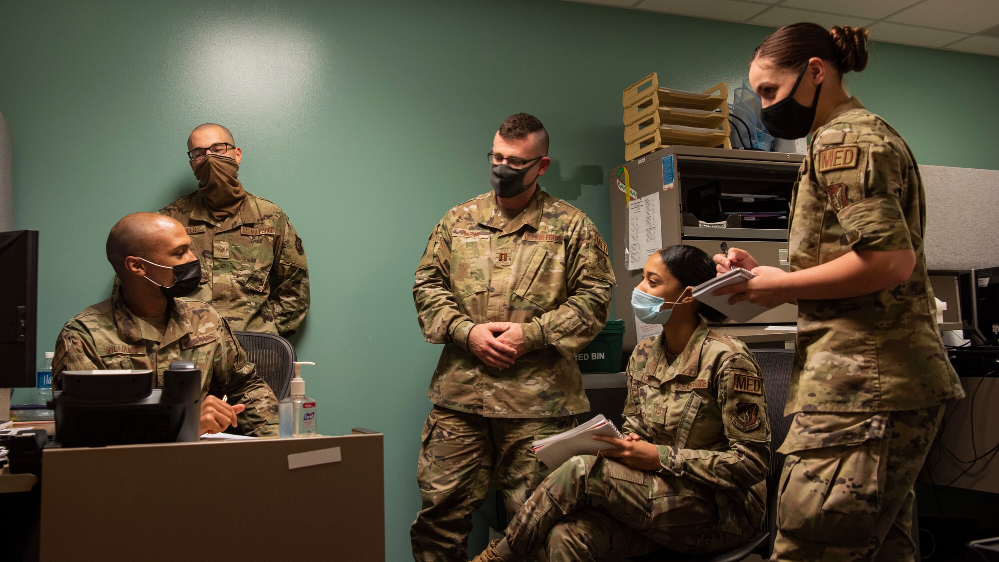 Airmen from 36th Medical Group Mental Health Flight converse during a meeting in their headquarters at Andersen Air Force Base, Guam, Jan. 28, 2021. During the last week of January, members of Andersen AFB recognized all the hard work done by Airmen in the Biomedical Science Corps in honor of the 56th Annual Biomedical Science Corps Appreciation Week. (U.S. Air Force photo by Senior Airman Aubree Owens)