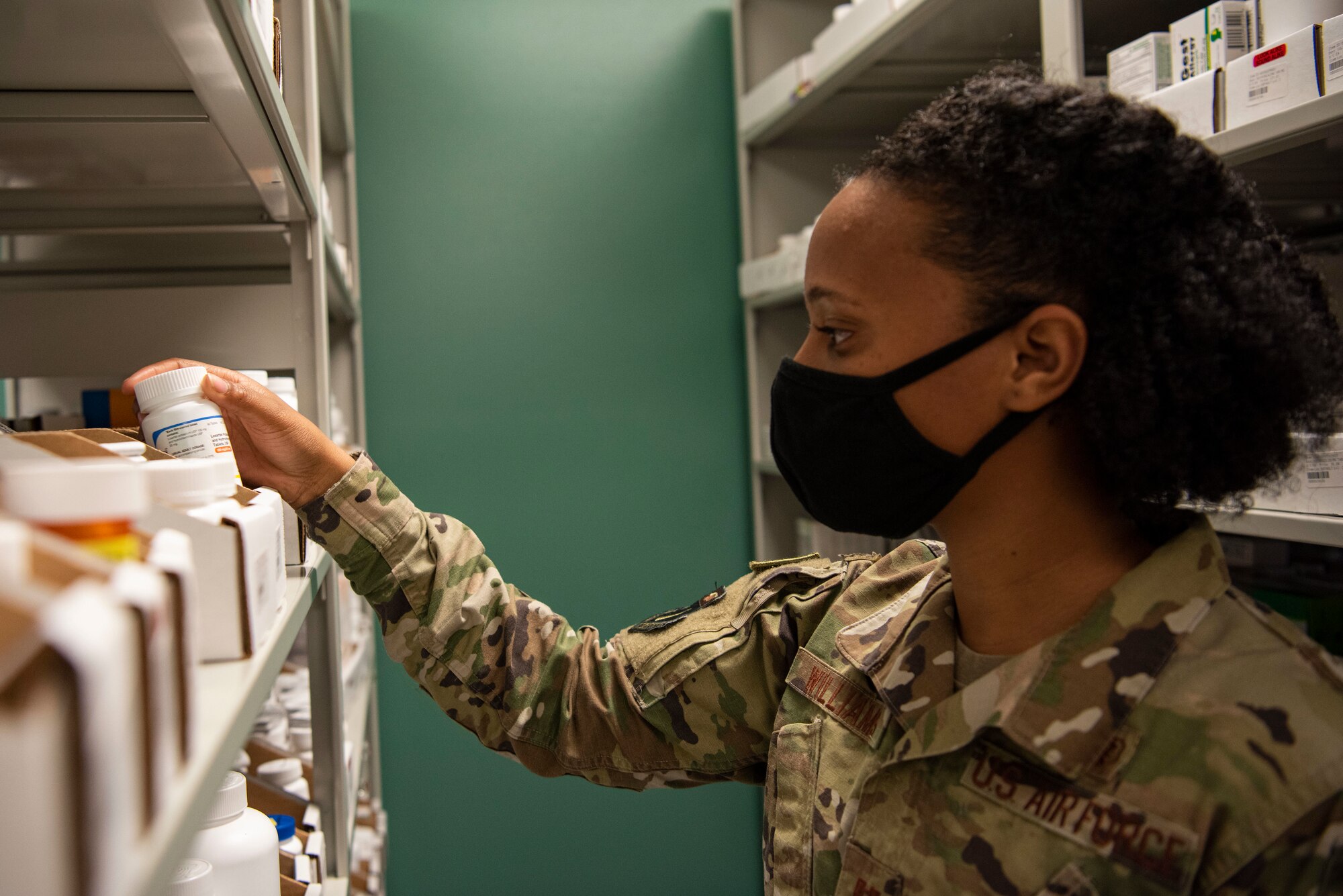 Capt. Ciera Williams, 36th Healthcare Operations Squadron chief of pharmacy operations, reaches for a medication in the pharmacy at Andersen Air Force Base, Guam, Jan. 28, 2021. During the last week of January, members of Andersen AFB recognized all the hard work done by Airmen in the Biomedical Science Corps in honor of the 56th Annual Biomedical Science Corps Appreciation Week. (U.S. Air Force photo by Senior Airman Aubree Owens)