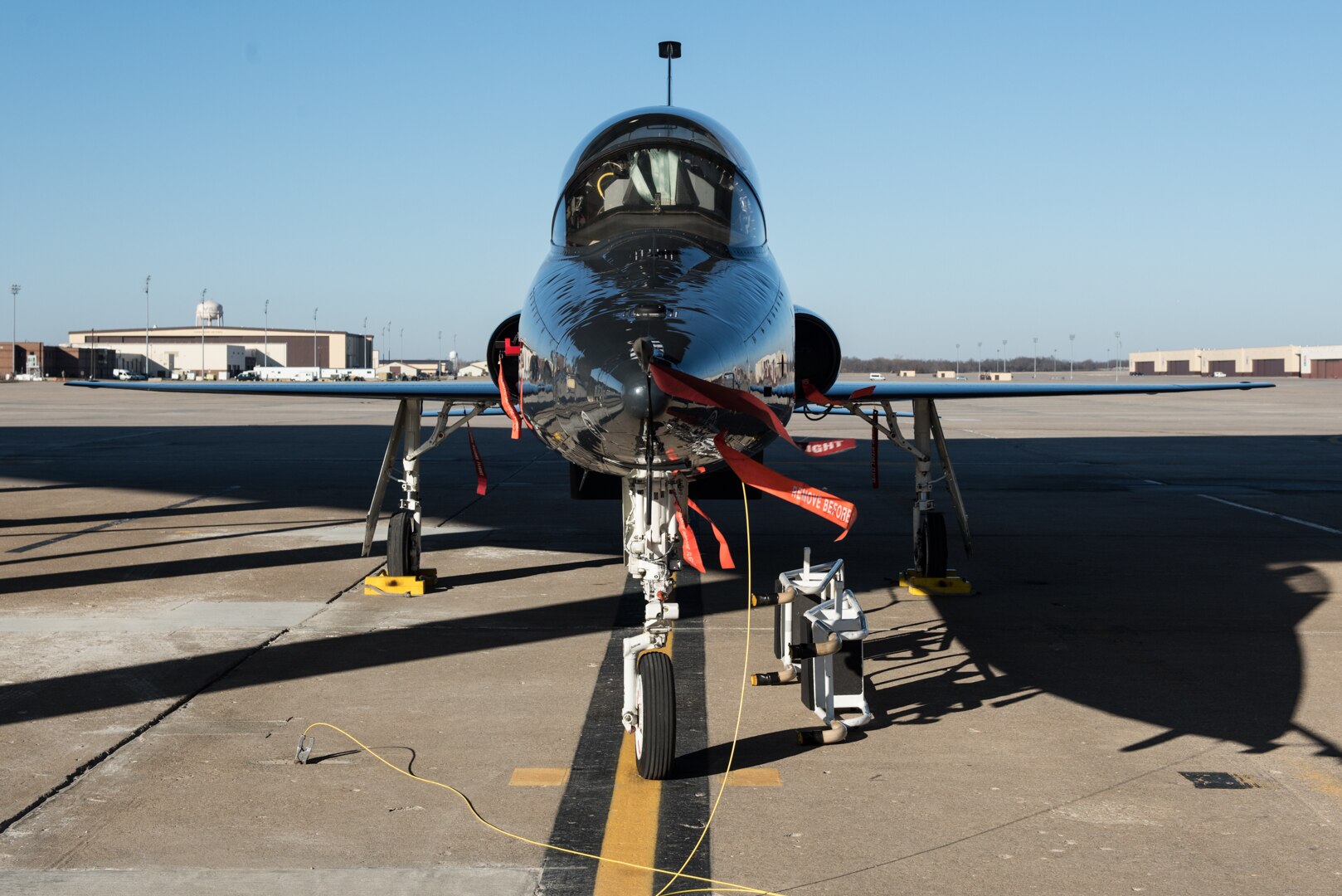 A T-38 Talon sits under the hardstand at Whiteman Air Force Base, Missouri, Jan. 12, 2021.  The Fiscal Year 2024 Defense Logistics Agency Military Construction project will enable R-12 refueling of T-38 aircraft near their parking apron with the new aircraft hydrant outlet pits. (U.S. Air Force photo by Airman 1st Class Christina Carter)