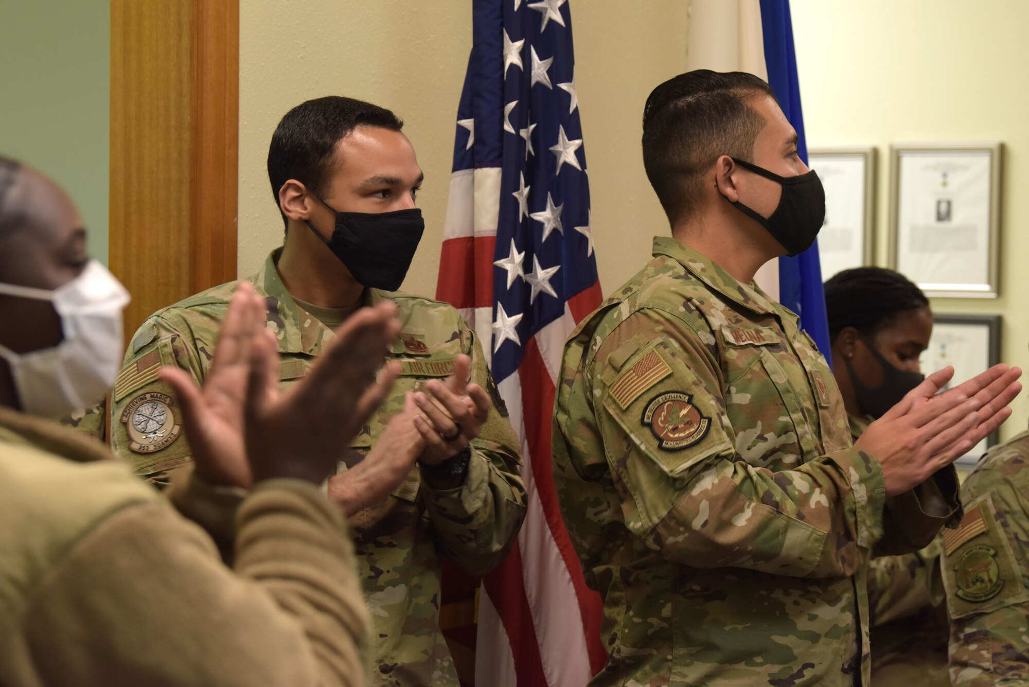 A group applauds for the unveiling of two classrooms being renamed after innovative historical figures, Jan. 8, 2021, at Kadena Air Base, Japan. The McDaniel Center hosted an open house to honor the service of the first American enlisted Airmen, Cpl. Edward Ward, and the first American enlisted aviator, Cpl. Vernon Lee Burge. (U.S. Air Force photo by Airman 1st Class Rebeckah Medeiros)