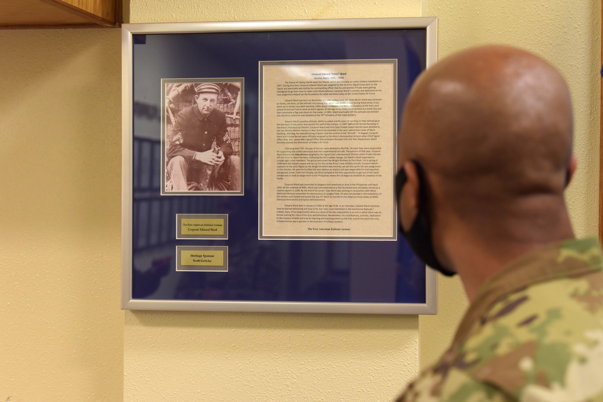 An Airman reads a description of Cpl. Edward “Eddie” Ward, Jan. 8, 2021, at Kadena Air Base, Japan. Ward assisted in airplane demonstrations and learned how to fly and maintain dirigibles amongst many other accomplishments throughout his 28 years in service. (U.S. Air Force photo by Airman 1st Class Rebeckah Medeiros)