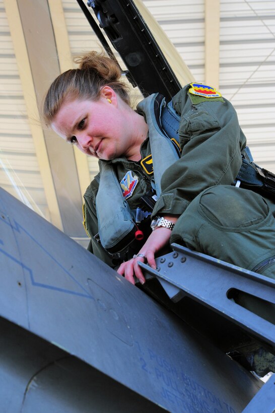 Maj. Jaime Nordin, 79th Fighter Squadron F-16 pilot, checks out the cockpit of an F-16 to ensure everything is in order, March 26, 2011. The Air Force has had women in fighter pilot roles since 1993. (U.S. Air Force photo / Airman 1st Class Daniel Phelps)