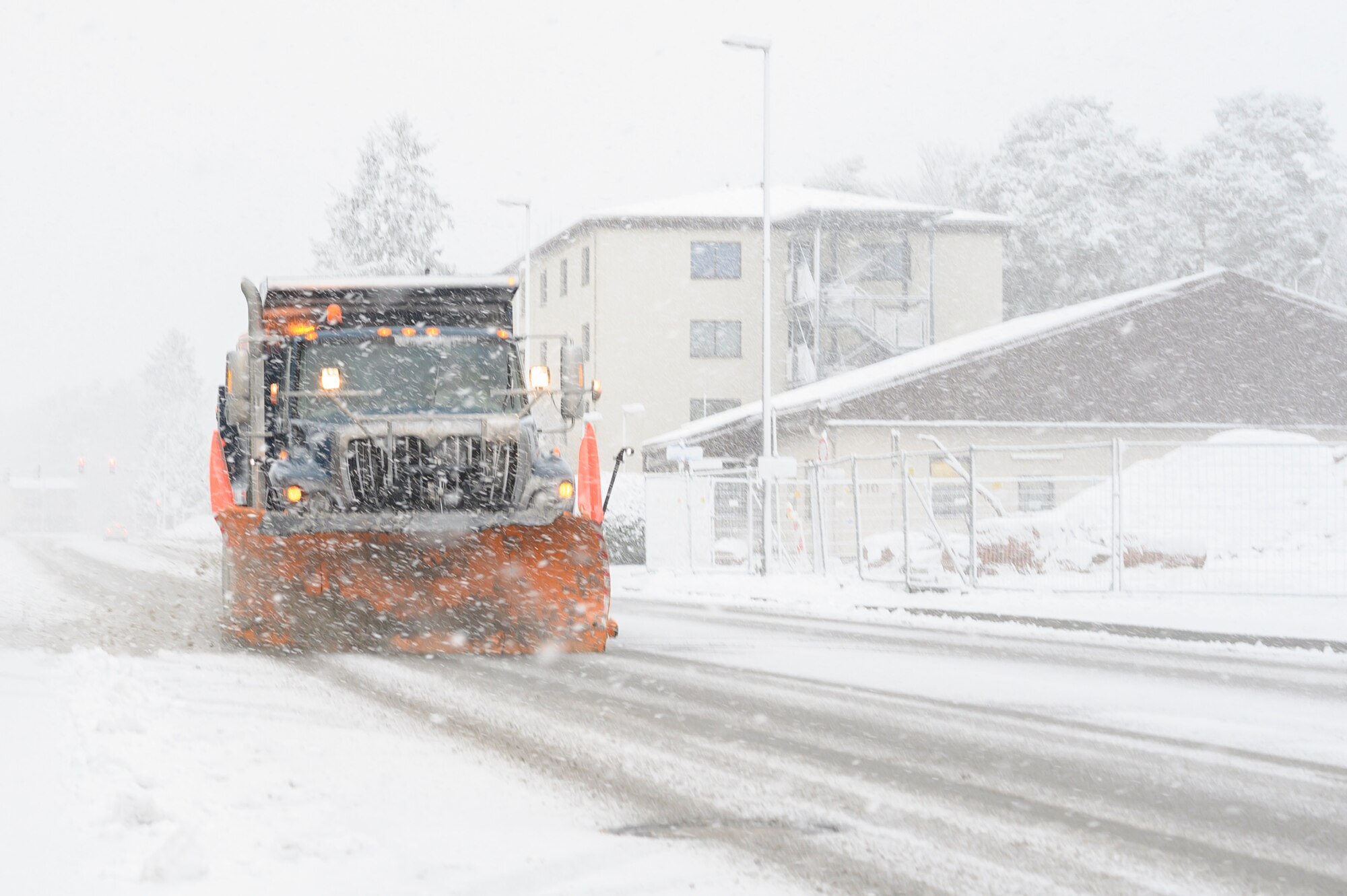 A dump truck removes snow.