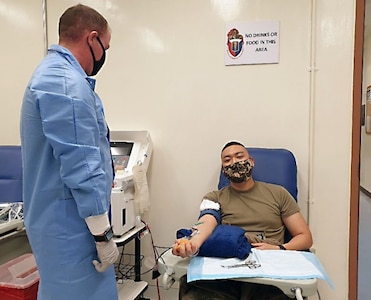 Sgt. Tae H. Ha, right, donates the first unit of apheresis platelets on Dec. 14, 2020, during the 95th Medical Detachment-Blood Support’s training at Camp Humphreys, South Korea. Also pictured is Sgt. Grider W. Gossett, the lab technician assisting with the donation.