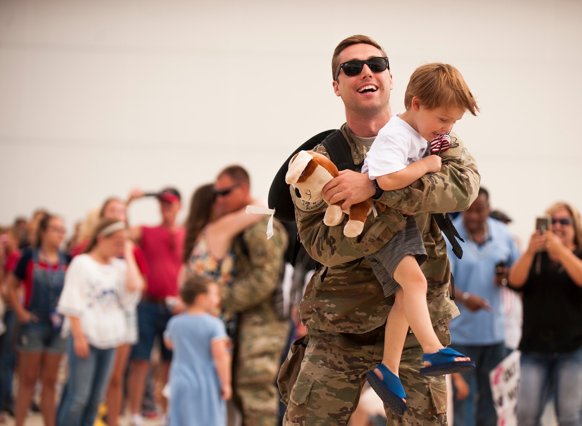  Airman holding son and smiling.