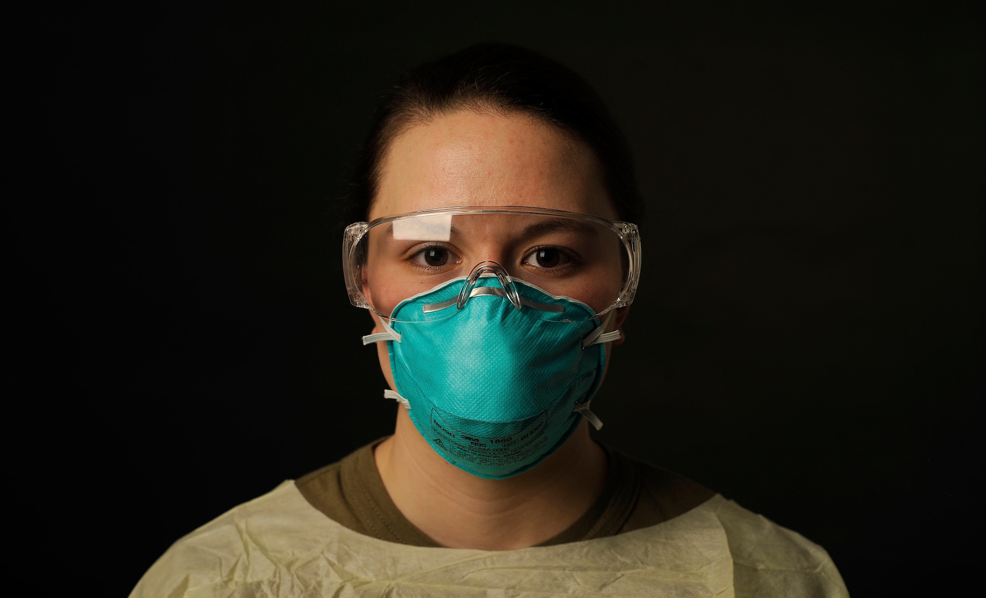U.S. Air Force Senior Airman Toula Farnsworth, a 354th Operational Medical Readiness Squadron medical technician, poses for a photo in COVID-19 proper protective equipment on Eielson Air Force Base, Alaska, Jan. 19, 2021. Farnsworth is responsible for administering the COVID-19 test and ensuring the test is accurate by preventing cross-contamination. (U.S. Air Force photo by Senior Airman Beaux Hebert)