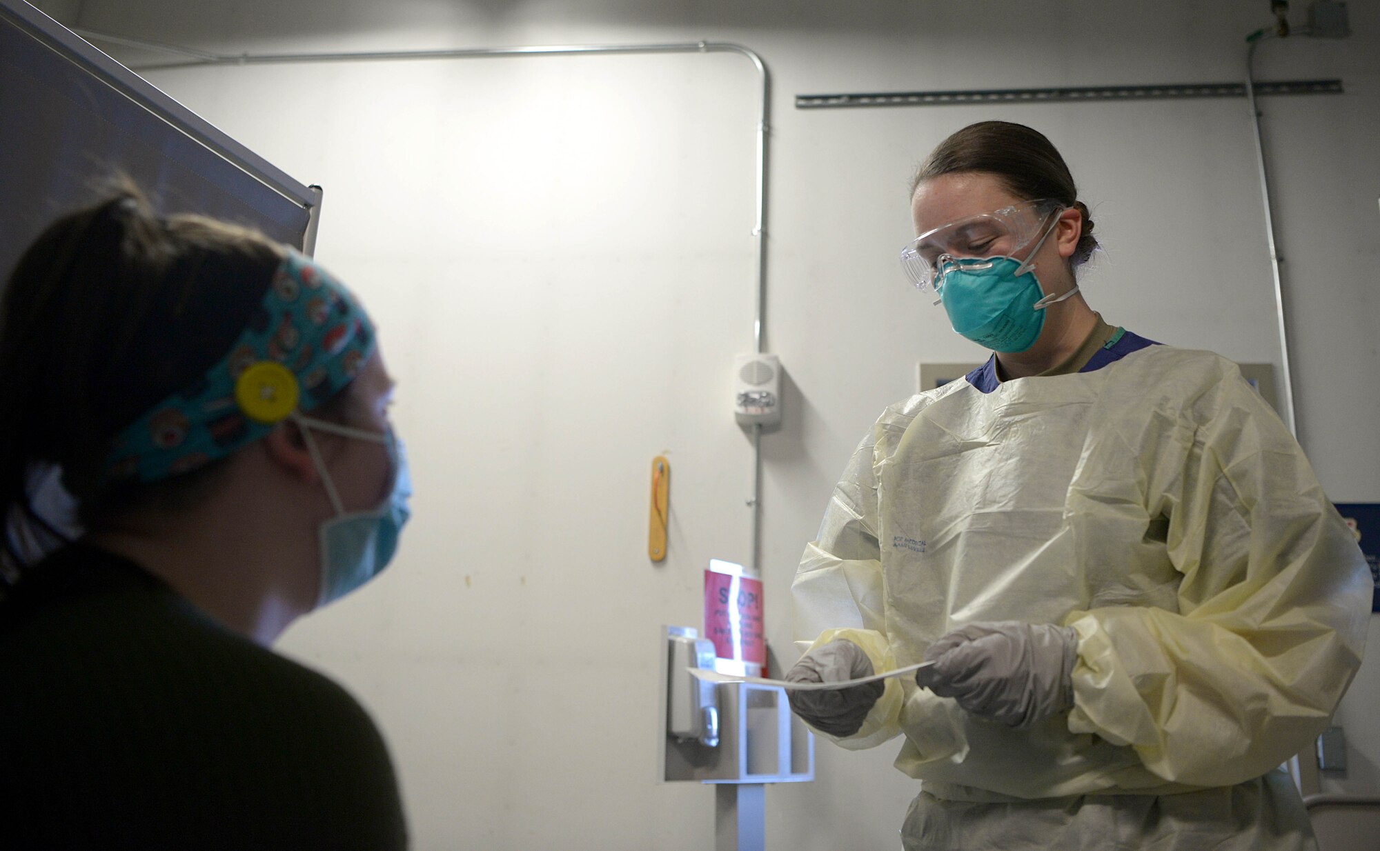 U.S. Air Force Senior Airman Toula Farnsworth, a 354th Operational Medical Readiness Squadron medical technician, practices testing a patient for COVID-19, Jan. 13, 2021. If an Eielson member suspects they have contracted COVID-19, the first place they go is the COVID-19 Clinic where Farnsworth and her team will ensure the patient receives a safe and accurate test. (U.S. Air Force photo by Senior Airman Beaux Hebert)