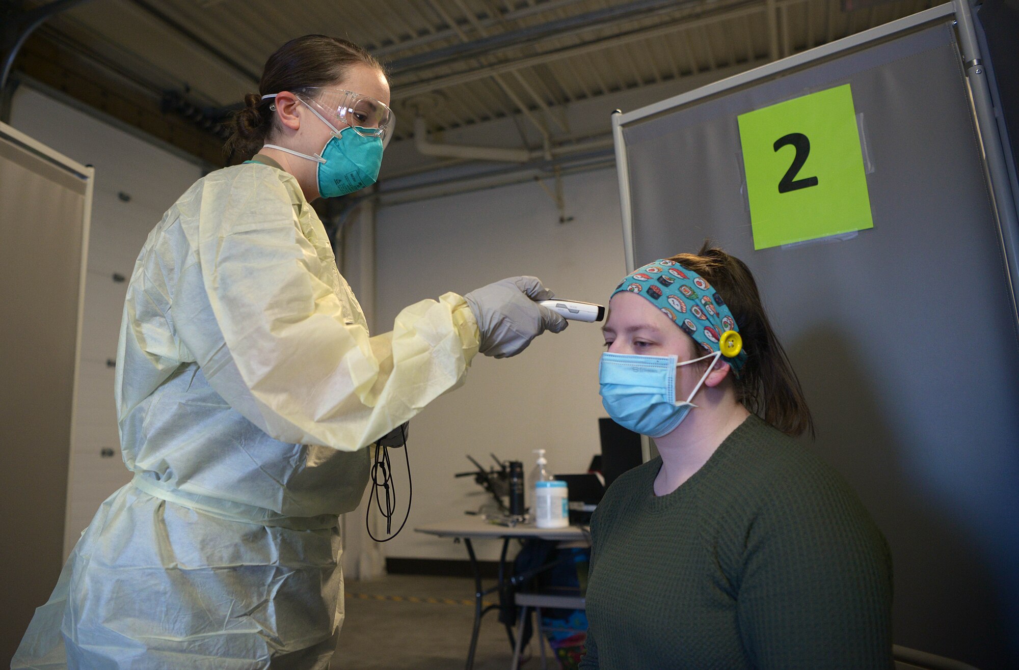 U.S. Air Force Senior Airman Toula Farnsworth, a 354th Operational Medical Readiness Squadron medical technician, takes a simulated patient’s temperature while practicing administering a  COVID-19 test Jan. 13, 2021, on Eielson Air Force Base, Alaska. It’s crucial for Farnsworth to maintain a sterile environment because not every patient that comes to the COVID-19 clinic will test positive. (U.S. Air Force photo by Senior Airman Beaux Hebert)
