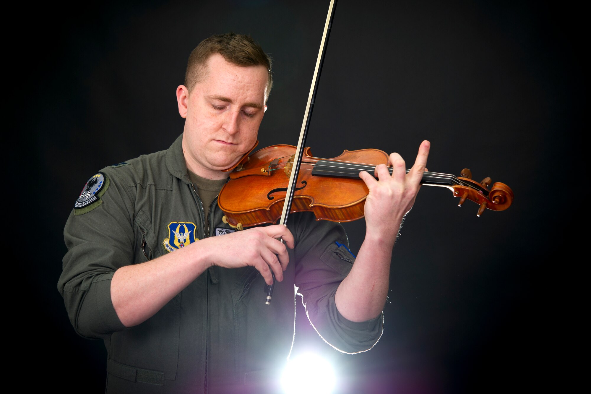 Capt. Rob Reilly, 434th Air Refueling KC-135 Stratotanker pilot, conducts a violin performance during a demonstration at Grissom Air Reserve Base, Indiana, Jan. 29, 2021. In addition to being a tanker pilot, Reilly sits as a first chair violinist with the Indinapolis Philharmonic Orchestra. (U.S. Air Force photo/Master Sgt. Benjamin Mota)