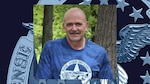 Mark Aicher wearing blue shirt with trees in the background overlaid on a navy blue backdrop