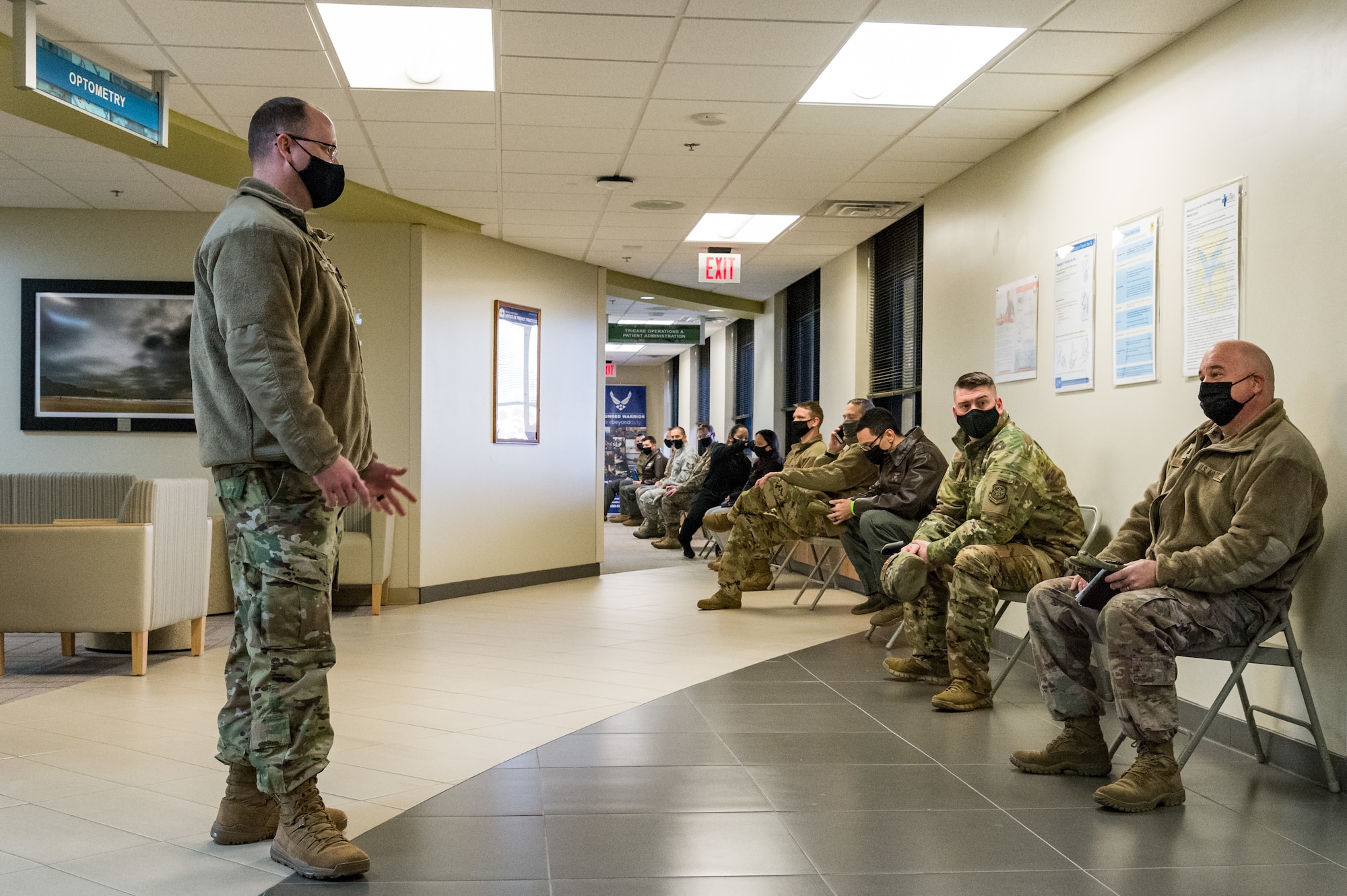 Master Sgt. Timothy Zacek, 436th Civil Engineer Squadron first sergeant, talks with Lt. Col. Brooks Wilkerson, 436th Mission Support Group deputy commander, as he awaits COVID-19 immunization in-processing at the 436th Medical Group Clinic Jan. 22, 2021, at Dover Air Force Base, Delaware. Wilkerson was among the first Team Dover senior leaders who voluntarily received the vaccine in accordance with Department of Defense guidance. The vaccine was granted emergency use authorization by the U.S. Food and Drug Administration for use in prevention of COVID-19. (U.S. Air Force photo by Roland Balik)