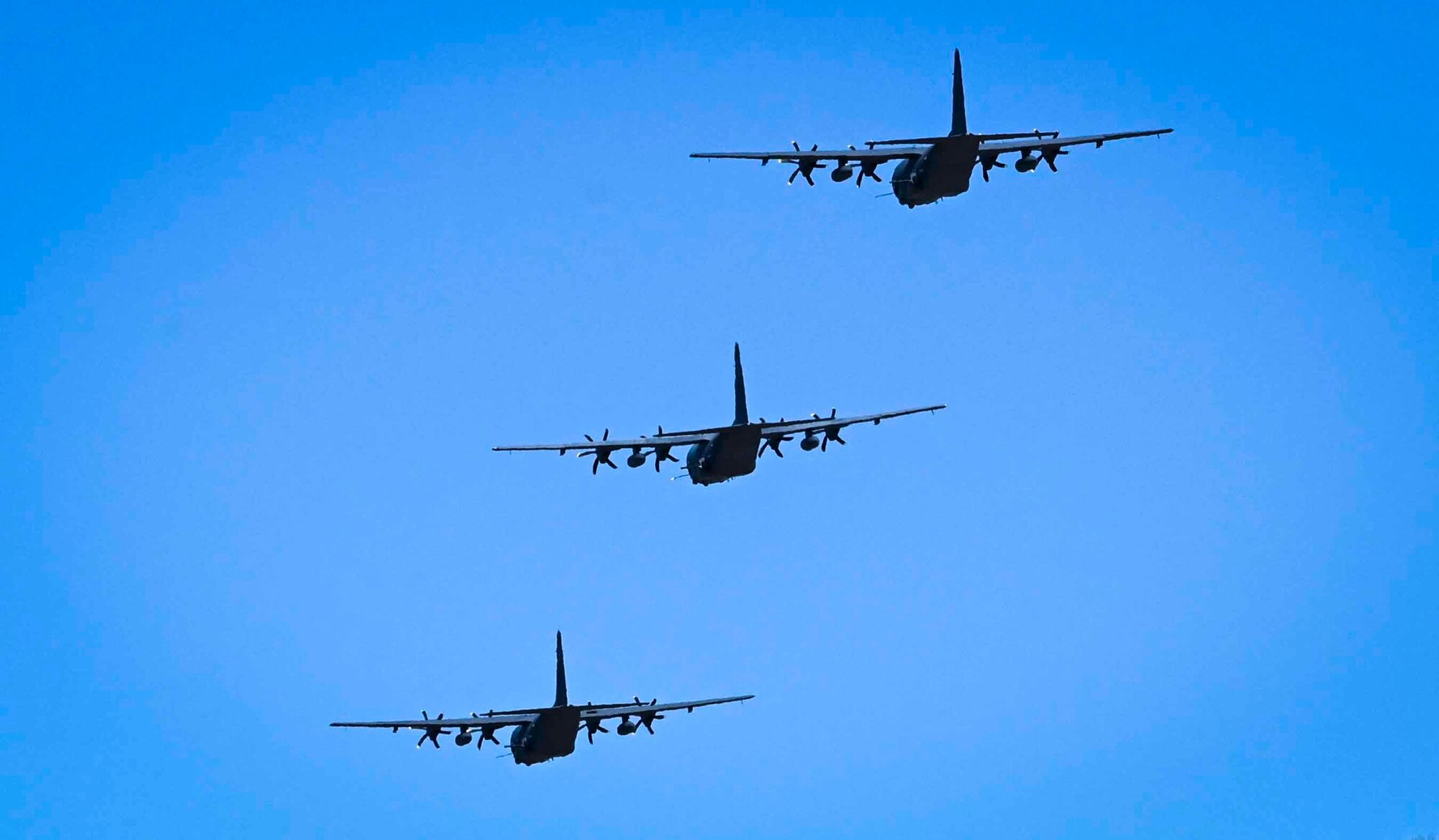 Three aircraft flying in the air.