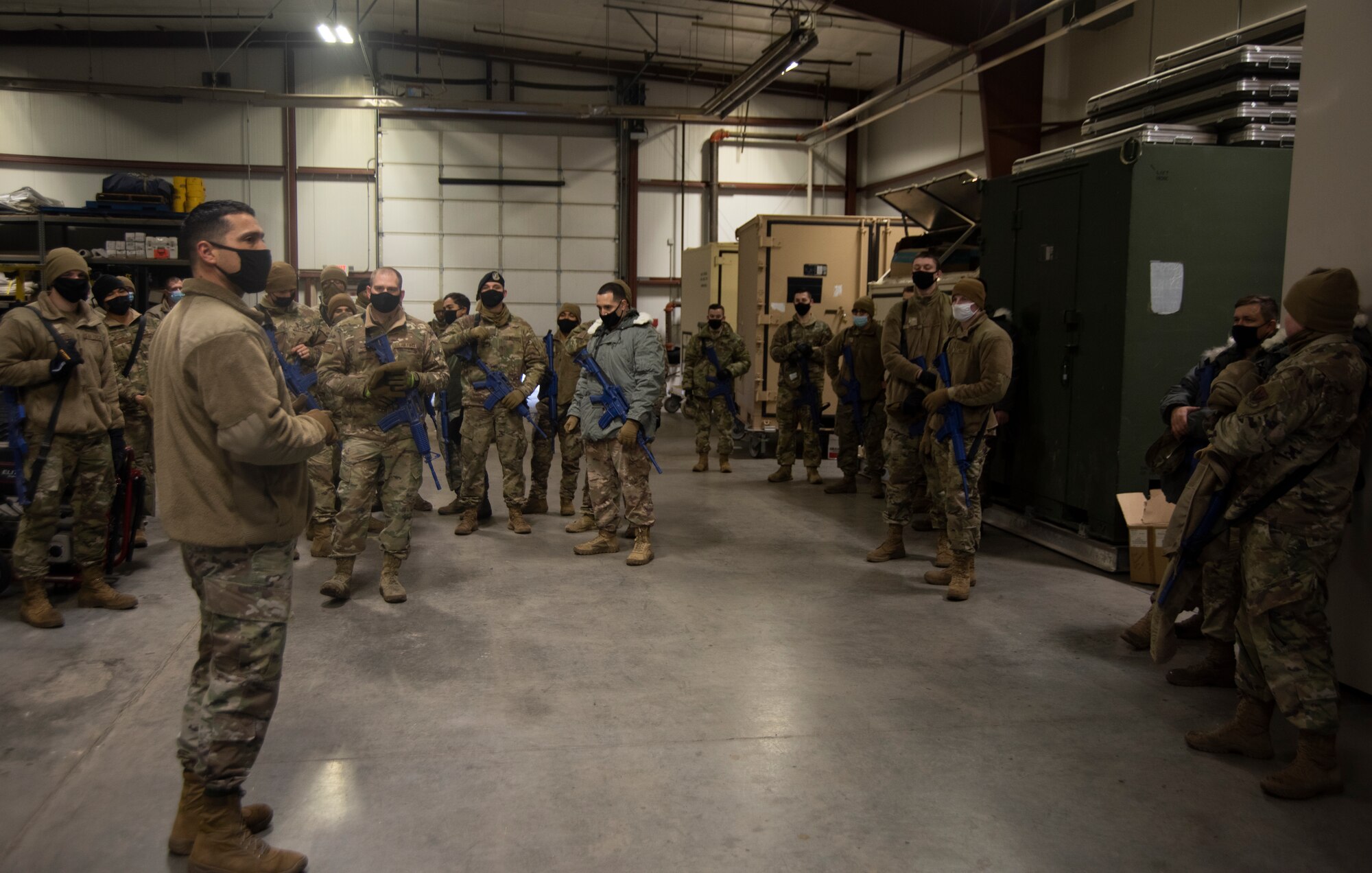 Chief Master Sgt. Erick Lizarraga briefs a group of Airmen about Raging Gunfighter.