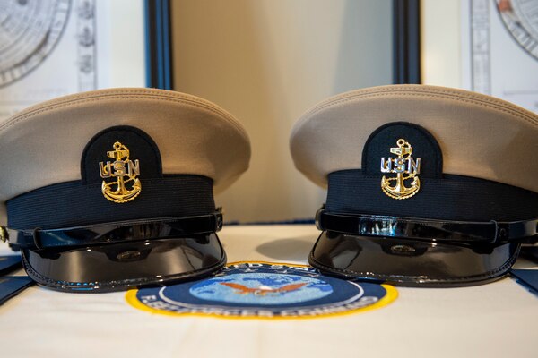 Adm. Christopher W. Grady, commander, U.S. Fleet Forces Command, presides over the pinning of Chief Intelligence Specialist Joshua Waldrop and Chief Aviation Aerographer’s Mate Travis Strait during a chief petty officer (CPO) pinning ceremony at the USFFC headquarters in Norfolk, Virginia.