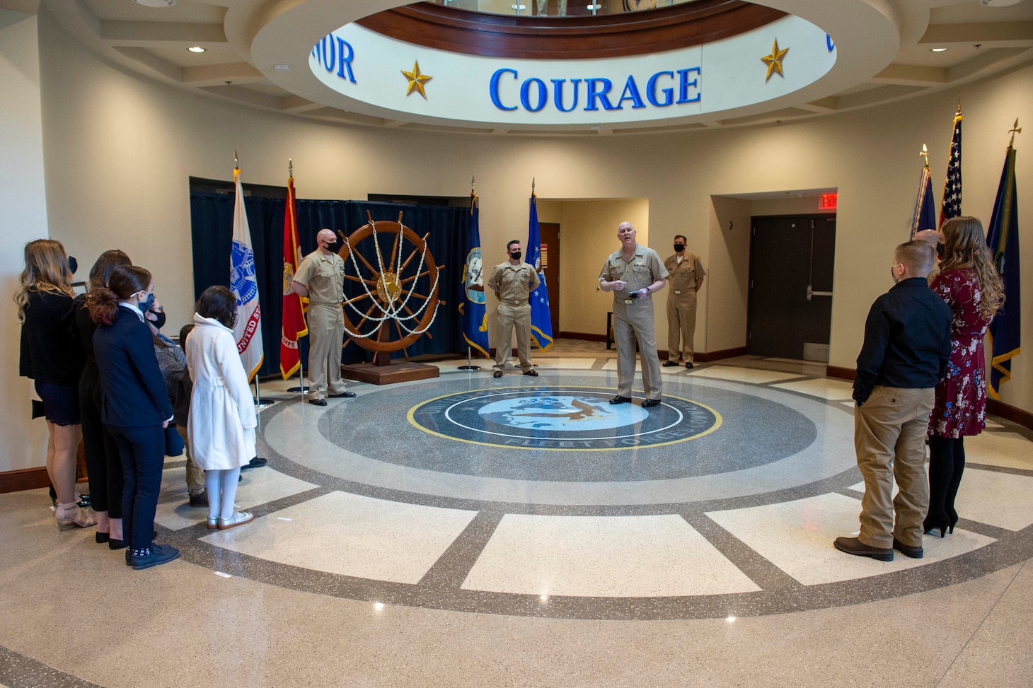 Adm. Christopher W. Grady, commander, U.S. Fleet Forces Command presides over the pinning of Chief Intelligence Specialist Joshua Waldrop and Chief Aviation Aerographer’s Mate Travis Strait during a chief petty officer (CPO) pinning ceremony at the USFFC headquarters in Norfolk, Virginia.