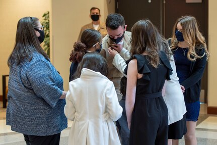 Chief Aviation Aerographer’s Mate Travis Strait of U.S. Fleet Forces Command (USFFC) receives his anchors from his family during a chief petty officer (CPO) pinning ceremony at the USFFC headquarters in Norfolk, Virginia.