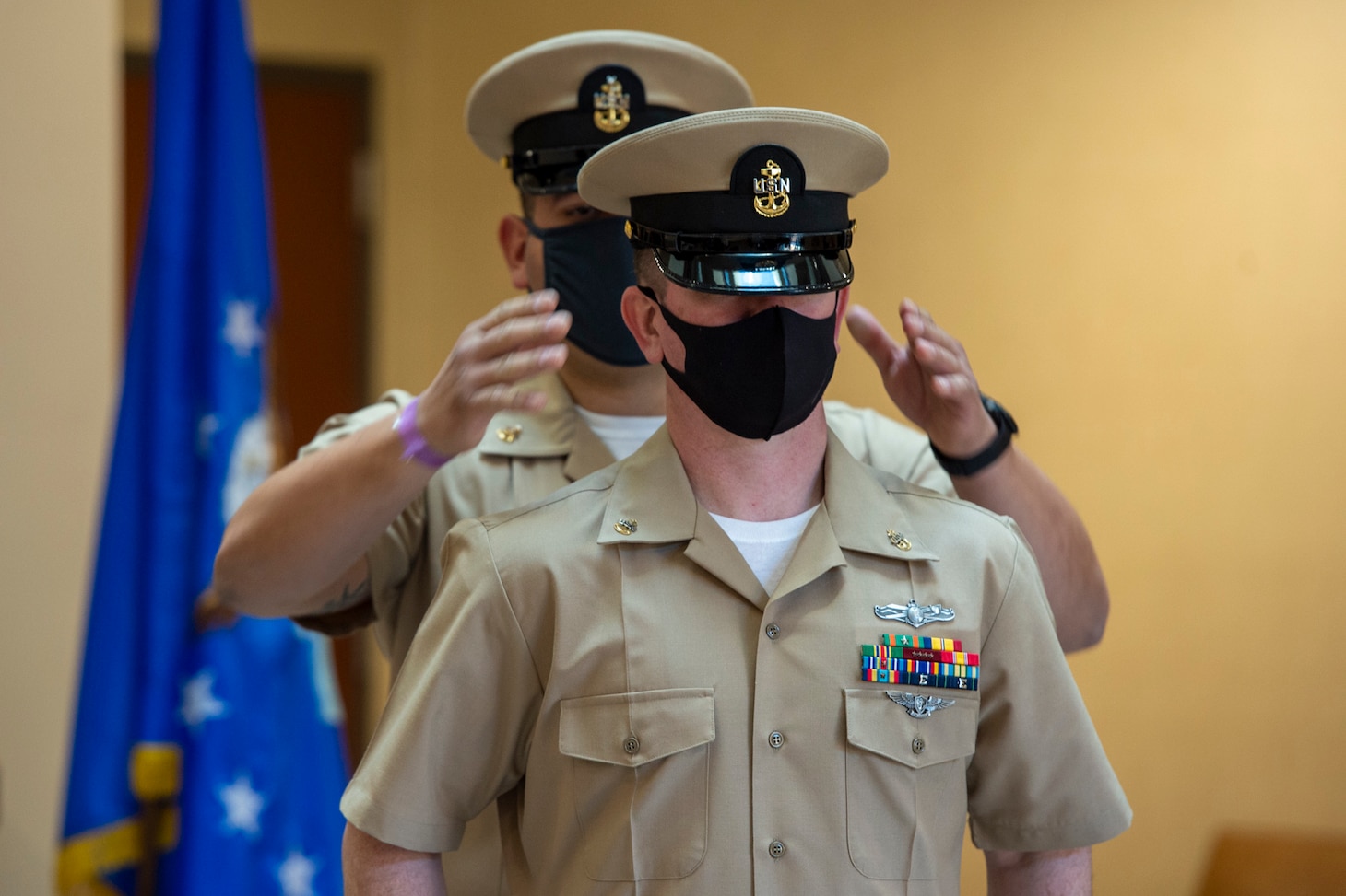 Chief Aviation Aerographer’s Mate Travis Strait of U.S. Fleet Forces Command (USFFC) receives his cover during a chief petty officer (CPO) pinning ceremony at the USFFC headquarters in Norfolk, Virginia.