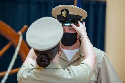 Chief Intelligence Specialist Joshua Waldrop of U.S. Fleet Forces Command (USFFC) receives his cover during a chief petty officer (CPO) pinning ceremony at the USFFC headquarters in Norfolk, Virginia.