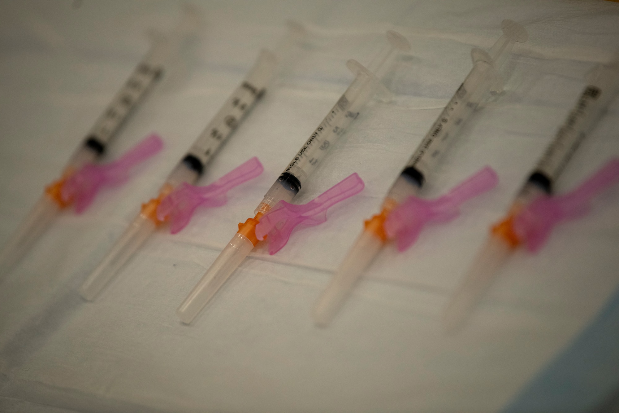 A table with six syringes containing the second dose of the COVID-19 vaccine.