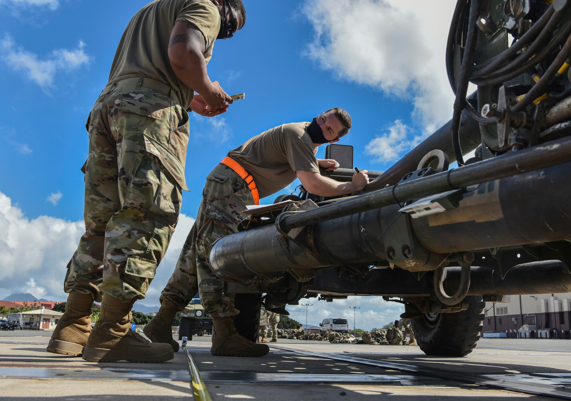 U.S. Air Force Staff Sgts. William McAtee and James Jackson, 735th Air Mobility Squadron air transportation supervisors, inspect an M19A3 howitzer as part of the joint inspection during Operation Bull Wings, an Emergency Deployment Readiness Exercise at Joint Base Pearl Harbor-Hickam, Jan. 21, 2021. The EDRE is a no-notice, rapid-deployment exercise designed to test a unit's ability to alert, marshal, and deploy forces and equipment to an emergency disaster or for contingency operations. (U.S. Air Force photo by Tech. Sgt. Anthony Nelson Jr.)