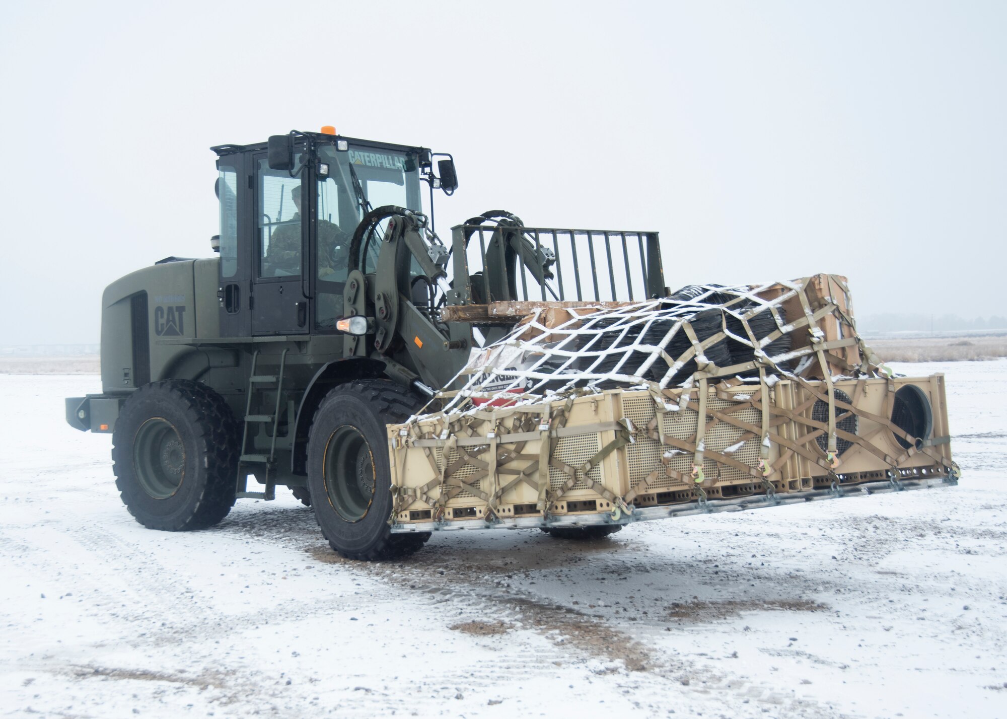 A picture of a forklift vehicle picking up an aircraft pallet.