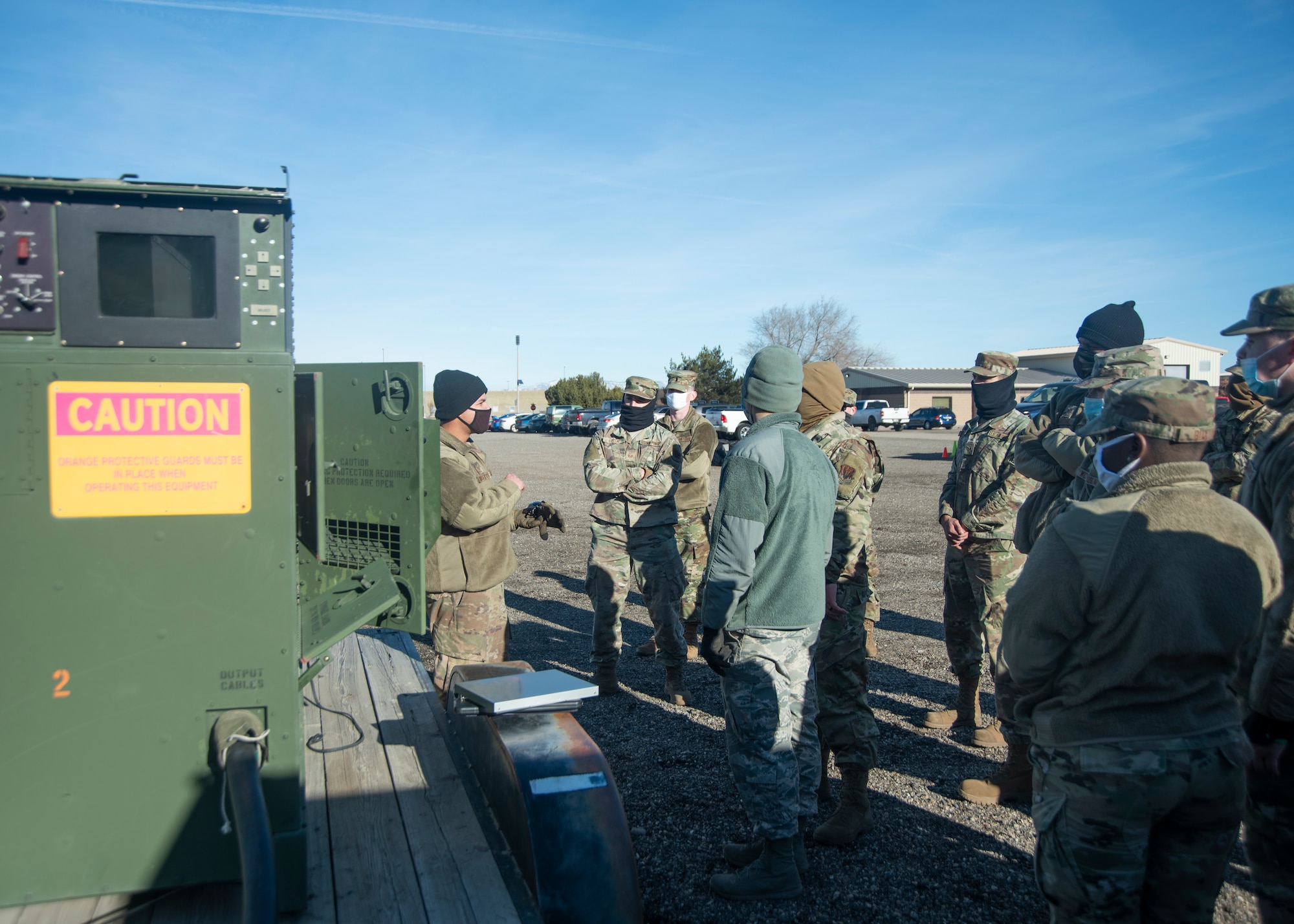 An Airman teaches a group of Airmen about the components of the generator.
