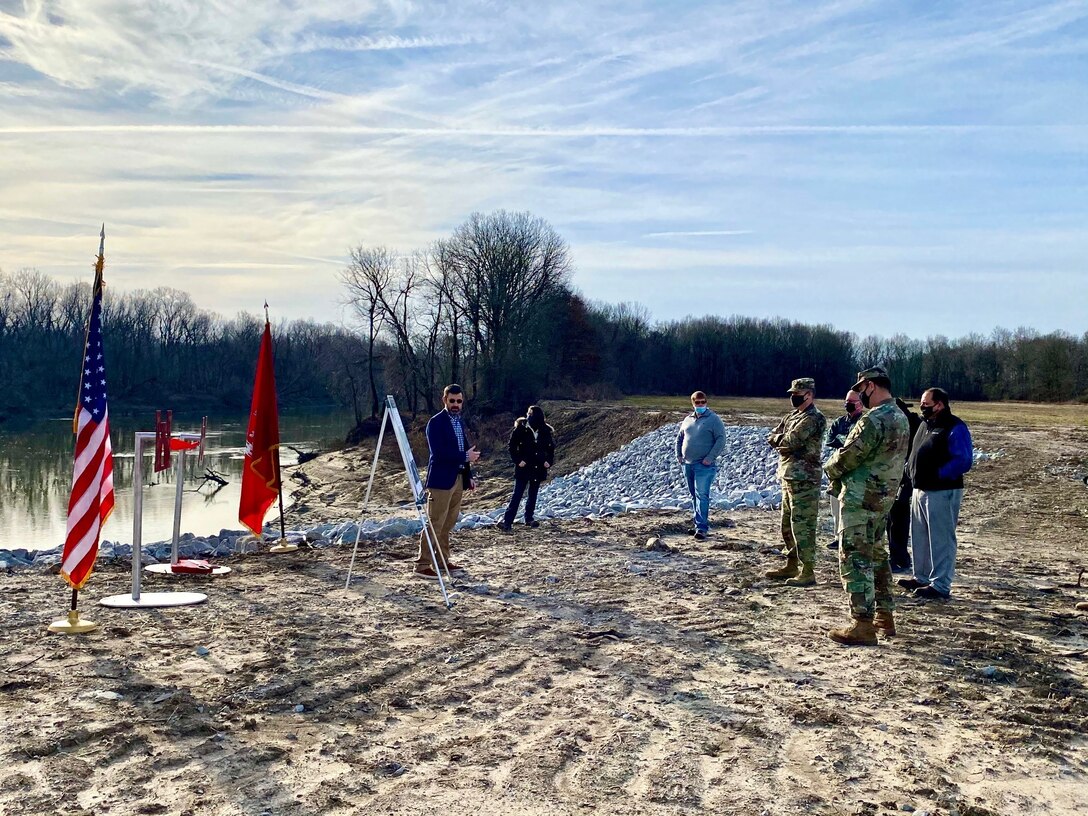 IN THE PHOTO, Memphis District Commander Col. Zachary Miller and other district leadership are briefed on the details of the St. Francis bridge (CR736) project at the exact site where the construction took place. Afterward, the group held a ribbon-cutting ceremony, symbolizing the victory and celebration of completing yet another significant project. (USACE photo by Jessica Haas)