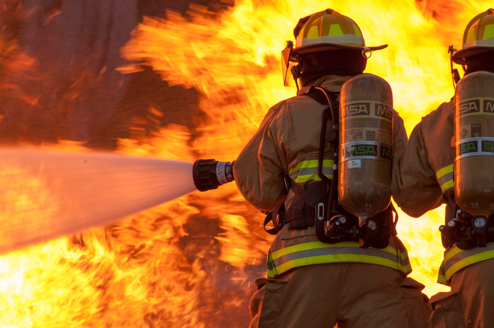 Members of the 122nd Fighter Wing Fire Department battle a simulated aircraft fire at the Combat Readiness Training Center, Alpena, Mich., on July 22 as part of the 122nd Fighter Wing's two-week long annual training.