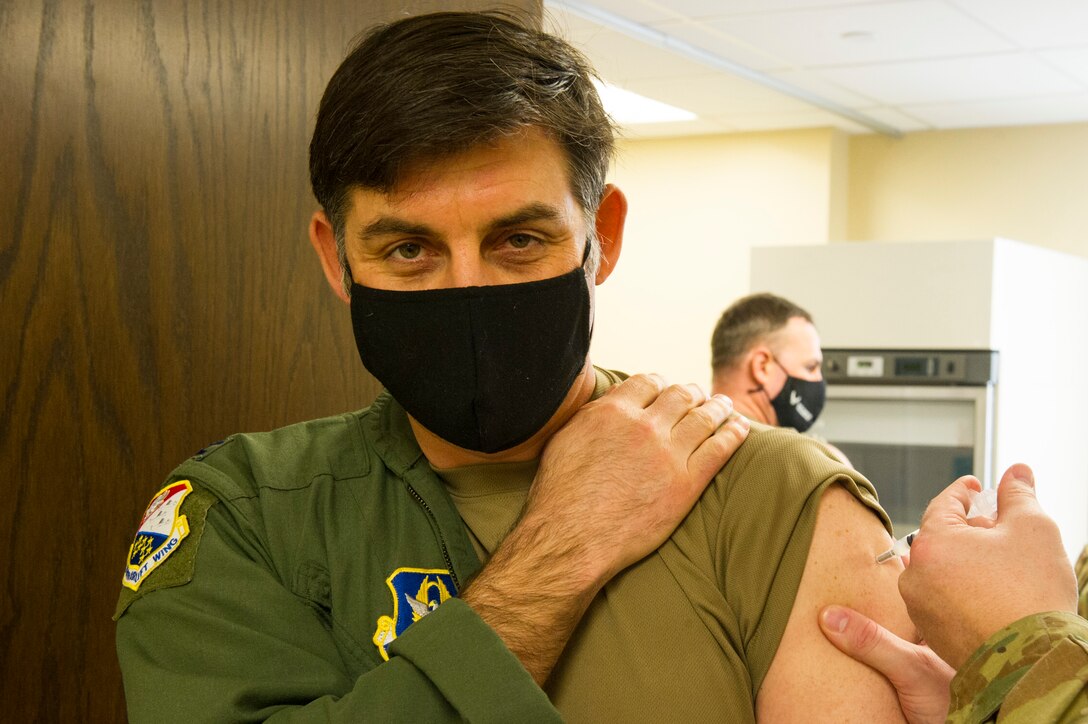 Col. Christopher Lay, 934th Airlift Wing commander, receives his COVID-19 vaccine from a 934th Aeromedical Staging Squadron medical technician at Minneapolis-St. Paul Air Reserve Station on Jan. 22, 2021. The 934th Airlift Wing initiated the distribution of the vaccine in an effort to combat the spread of the COVID-19 virus. (U.S. Air Force photo by Chris Farley)