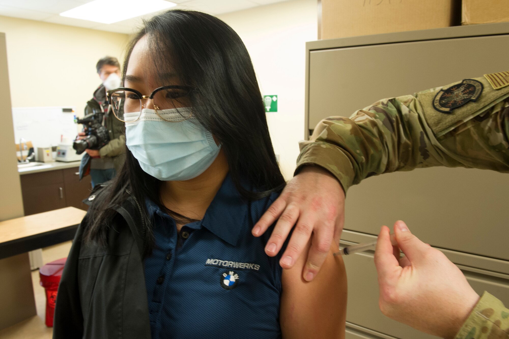 Staff Sgt. Amanda Thao, 934th Security Forces Squadron, receives her COVID-19 vaccine from a 934th Aeromedical Staging Squadron medical technician at Minneapolis-St.Paul Air Reserve Station on Jan. 22, 2021. The 934th Airlift Wing initiated the distribution of the vaccine in an effort to combat the spread of the COVID-19 virus. (U.S. Air Force photo by Chris Farley)