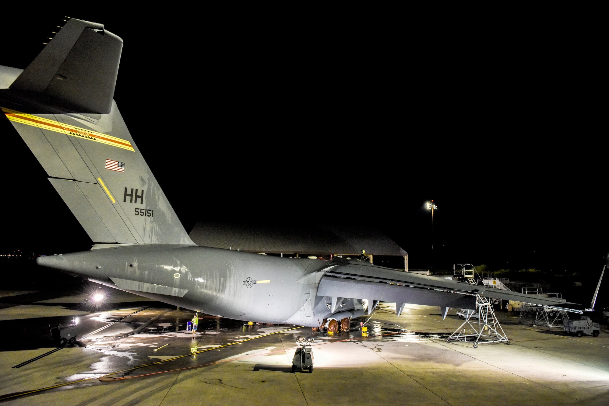 A U.S. Air Force C-17 Globemaster III sits on the flightline after an evening bath at Joint Base Pearl Harbor-Hickam, Hawaii, Jan. 7, 2020.  Contractors with the 15th Aircraft Maintenance Squadron are responsible for washing aircraft assigned to the 535th Airlift Squadron.  (U.S. Air Force photo by Tech. Sgt. Anthony Nelson Jr.)