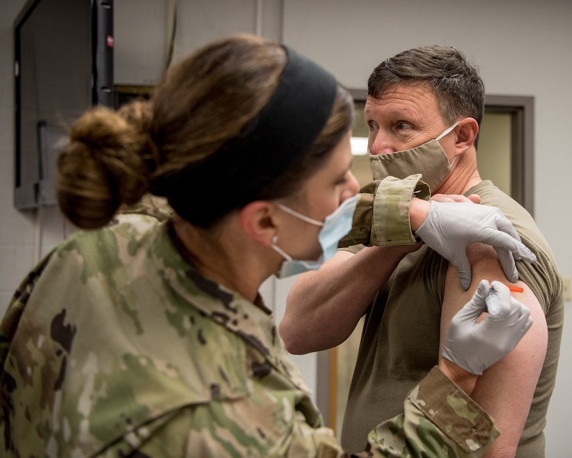 Brig. Gen. Jeffrey L. Wilkinson (right), Kentucky’s assistant adjutant general for Air, is administered a COVID-19 vaccination by Master Sgt. Natasha Perry, a medic with the 123rd Medical Group, at the Kentucky Air National Guard Base in Louisville Ky., Jan. 9, 2021. (U.S. Air National Guard photo by Staff Sgt. Joshua Horton)