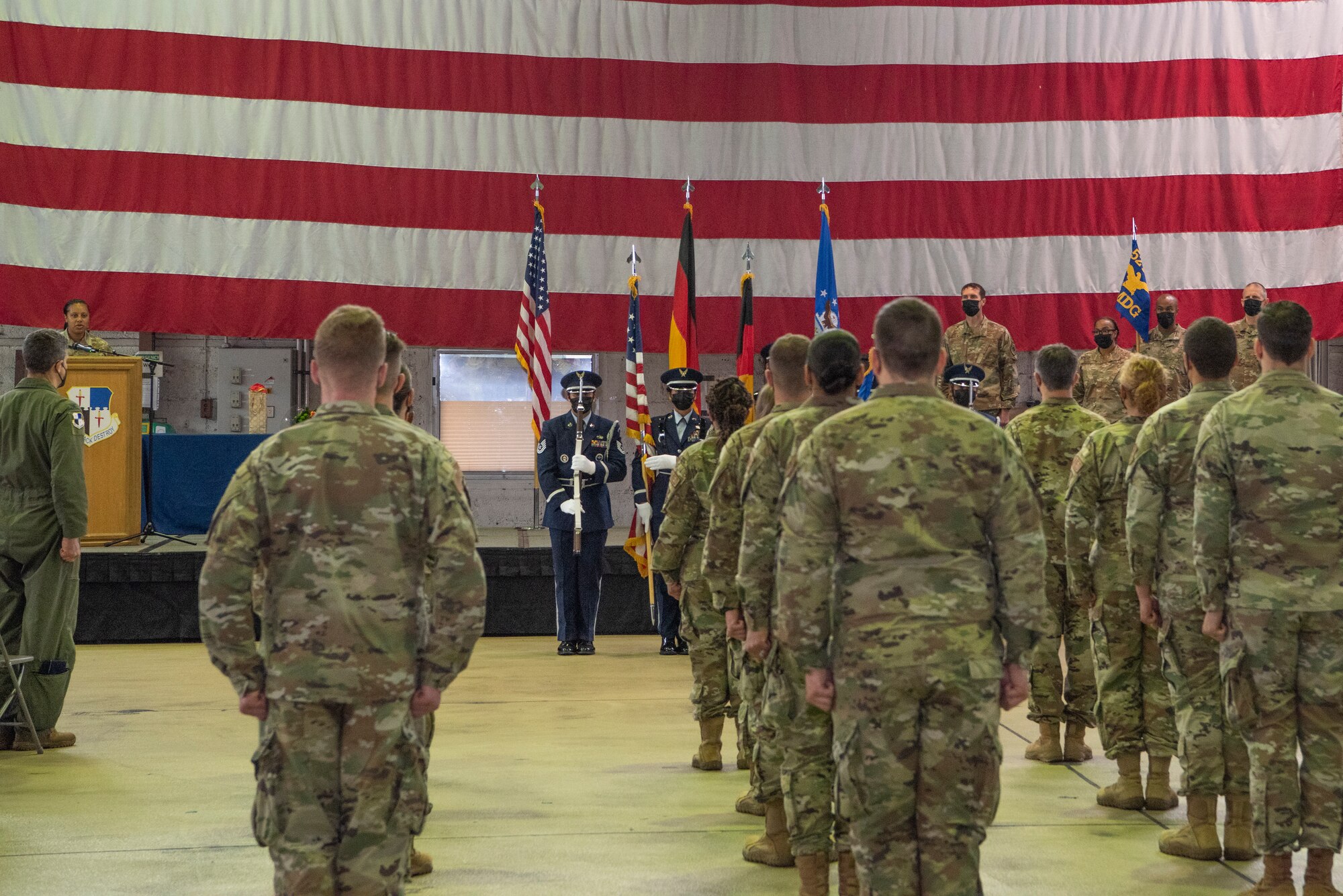 U.S. Air Force members of the 52nd Medical Group stand at attention for the Presentation of Colors during the 52nd MDG change of command ceremony June 30, 2021, on Spangdahlem Air Base, Germany. The 52nd MDG provides medical and dental services to nearly 9,500 beneficiaries at Spangdahlem Air Base and its four geographically separated units. (U.S. Air Force photo by Tech. Sgt. Anthony Plyler)